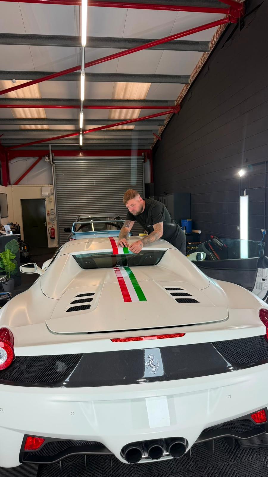 Ferrari stripe graphics being installed by T&W Automotive